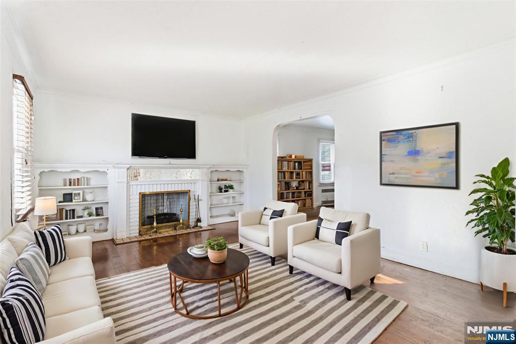327 Field Place Hillside, NJ 07205 - Photo 2 of 18 a living room with furniture a fireplace and a flat screen tv