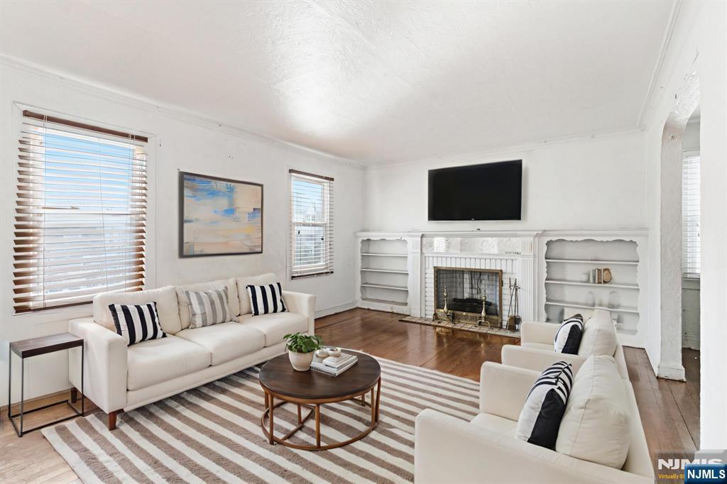 327 Field Place Hillside, NJ 07205 - Photo 3 of 18 a living room with furniture a fireplace and a flat screen tv