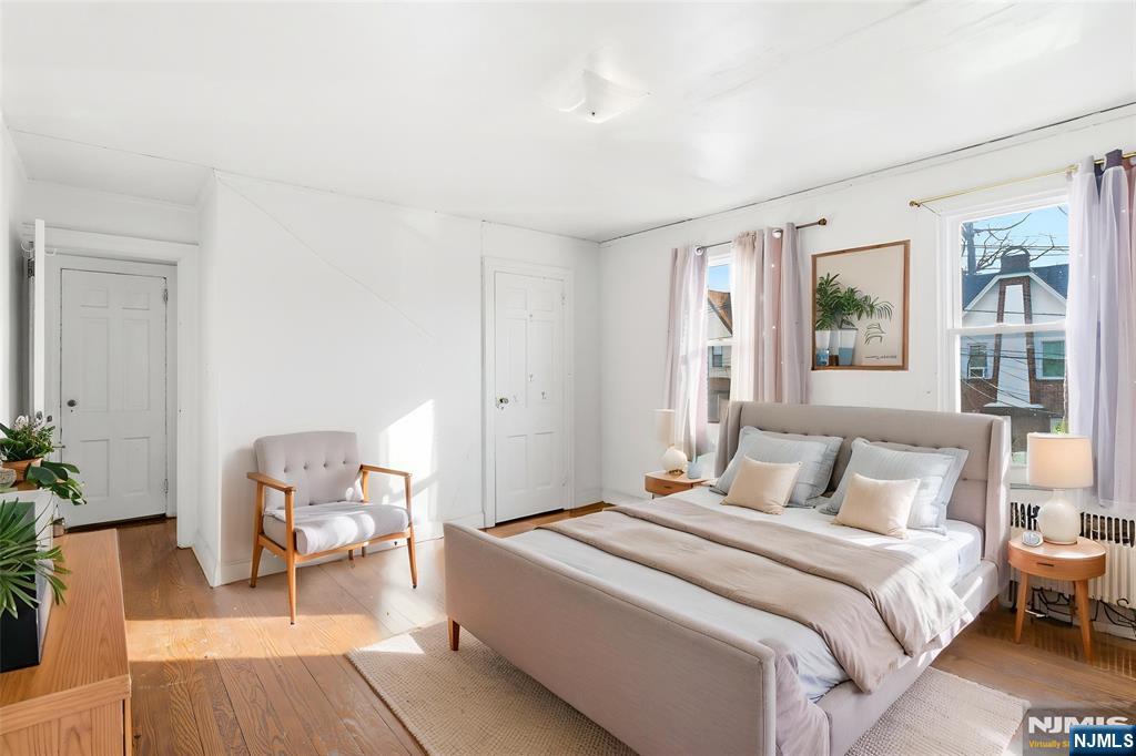 327 Field Place Hillside, NJ 07205 - Photo 7 of 18 a bedroom with a bed and chair