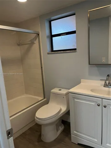 a bathroom with a toilet sink and a shower