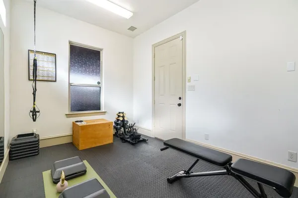 a room with furniture and a air conditioner vent