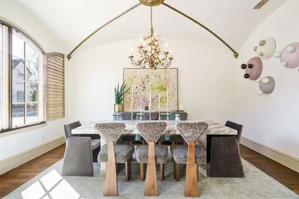 a view of a dining room with furniture and chandelier