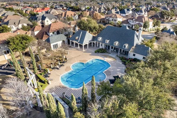 an aerial view of a house with yard swimming pool and outdoor seating