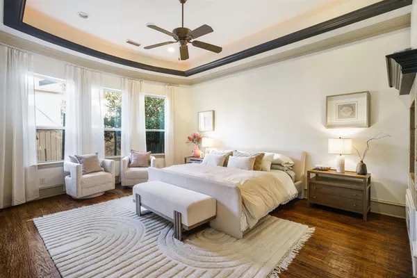 a bedroom with a large bed couch and a window