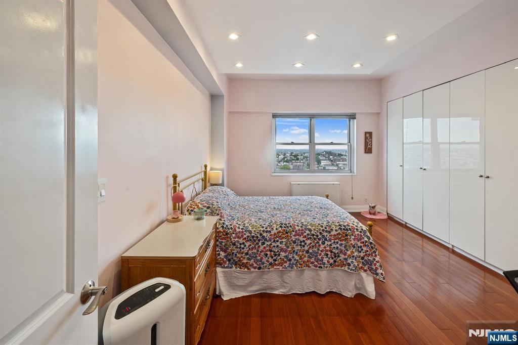 6600 JFK Boulevard East, Unit 23J West New York, NJ 07093 - Photo 11 of 26 a bedroom with a bed and a window