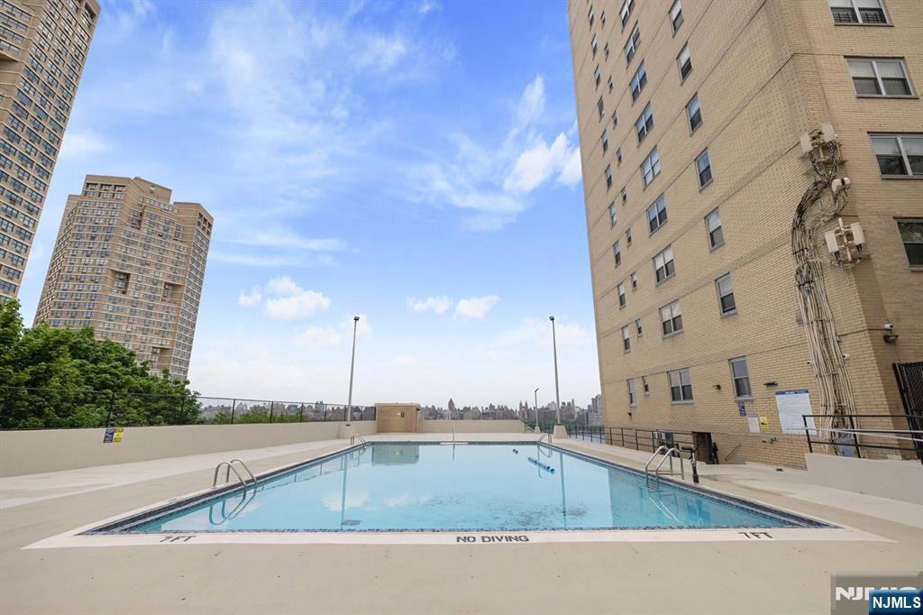 6600 JFK Boulevard East, Unit 23J West New York, NJ 07093 - Photo 15 of 26 a view of a swimming pool with a chairs