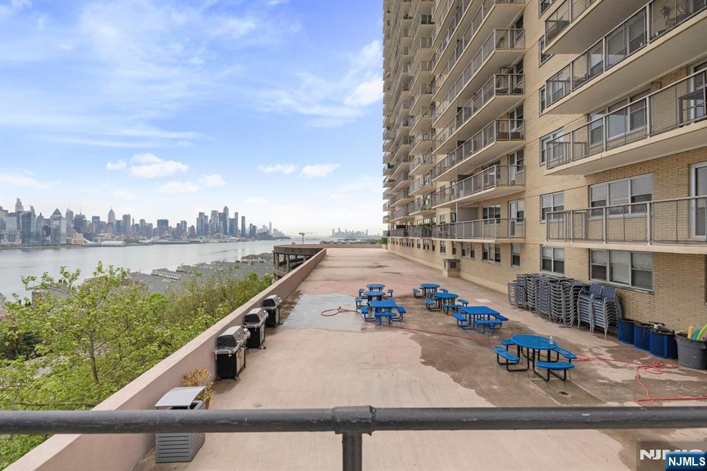 6600 JFK Boulevard East, Unit 23J West New York, NJ 07093 - Photo 17 of 26 a view of swimming pool with outdoor seating and city view