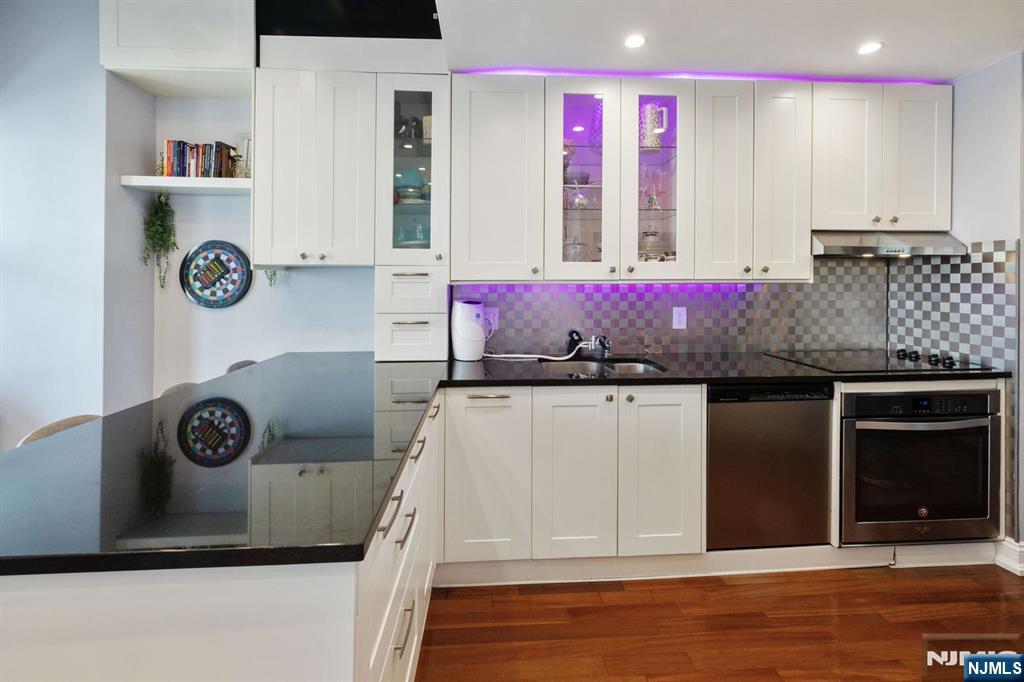 6600 JFK Boulevard East, Unit 23J West New York, NJ 07093 - Photo 2 of 26 a bathroom with a granite countertop sink and a mirror