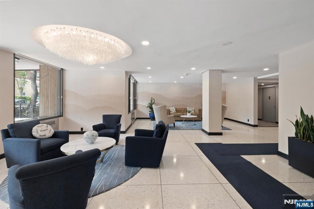 6600 JFK Boulevard East, Unit 23J West New York, NJ 07093 - Photo 24 of 26 a lobby with furniture and a potted plant