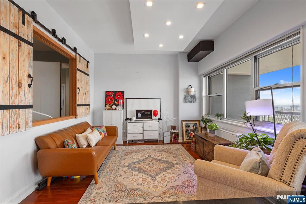 6600 JFK Boulevard East, Unit 23J West New York, NJ 07093 - Photo 26 of 26 a living room with furniture and a wooden floor