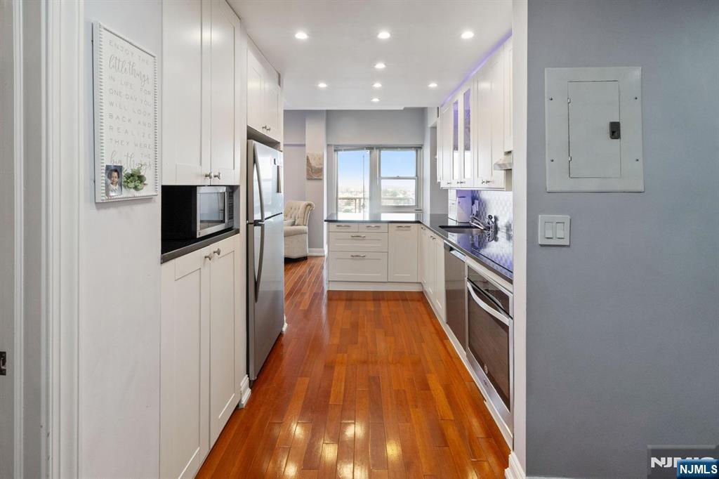 6600 JFK Boulevard East, Unit 23J West New York, NJ 07093 - Photo 3 of 26 a kitchen with stainless steel appliances a refrigerator and a stove top oven