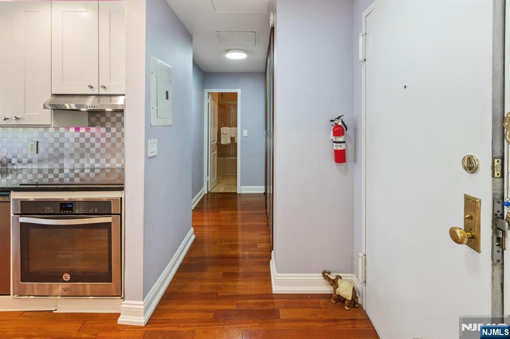 6600 JFK Boulevard East, Unit 23J West New York, NJ 07093 - Photo 4 of 26 a view of a hallway with wooden floor and staircase