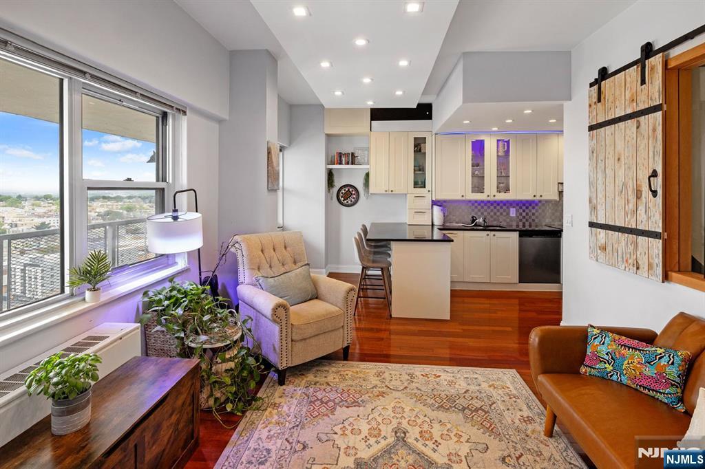 6600 JFK Boulevard East, Unit 23J West New York, NJ 07093 - Photo 7 of 26 a living room with furniture and a large window