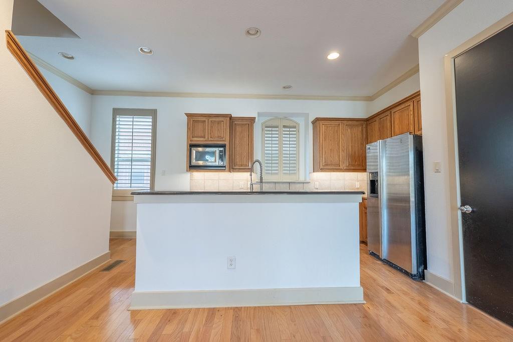 2706 Floyd Street Dallas, TX 75204 - Photo 11 of 22 a kitchen with stainless steel appliances a refrigerator and a stove