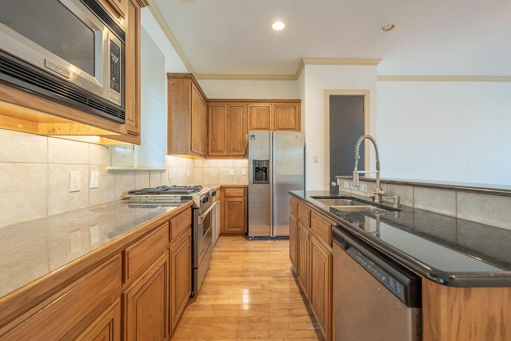 2706 Floyd Street Dallas, TX 75204 - Photo 12 of 22 a kitchen with stainless steel appliances granite countertop a sink stove and refrigerator