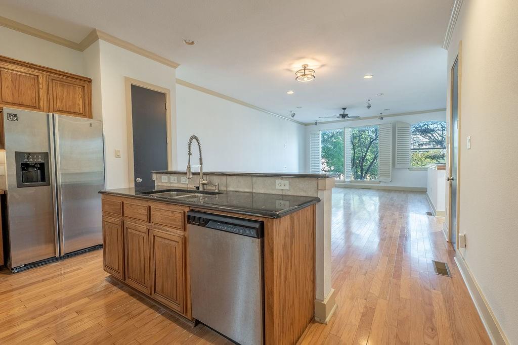 2706 Floyd Street Dallas, TX 75204 - Photo 13 of 22 a kitchen with kitchen island granite countertop a sink cabinets and stainless steel appliances