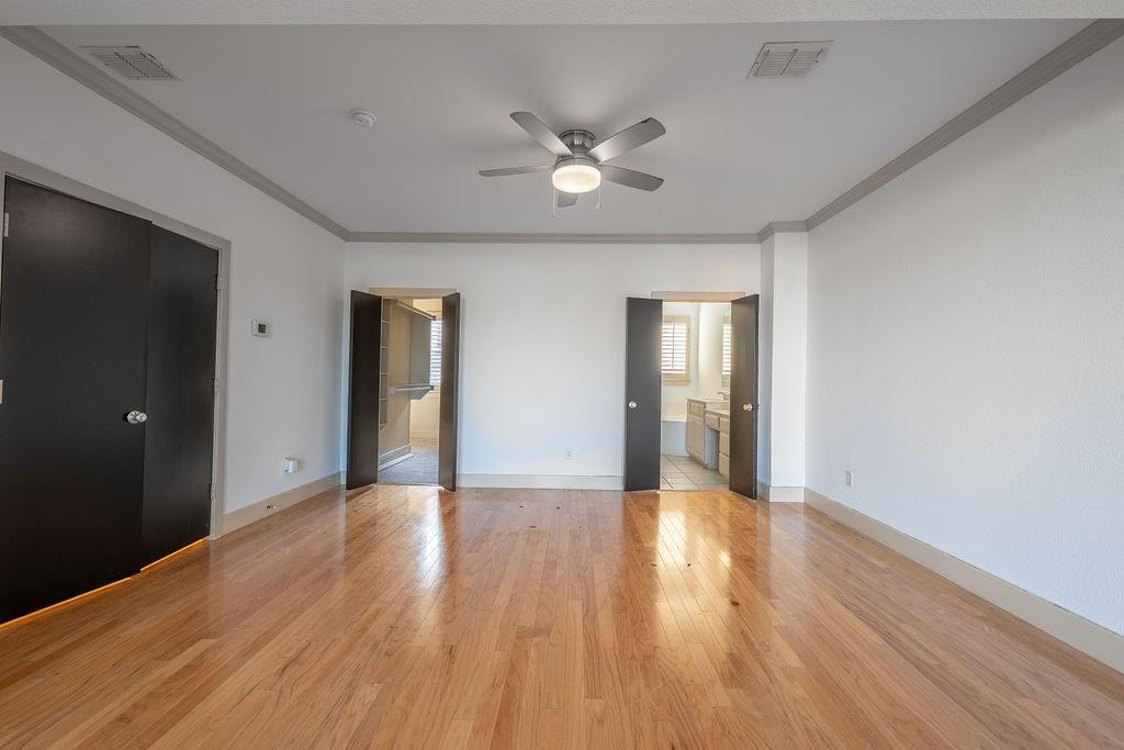 2706 Floyd Street Dallas, TX 75204 - Photo 15 of 22 a view of an empty room with wooden floor and a ceiling fan