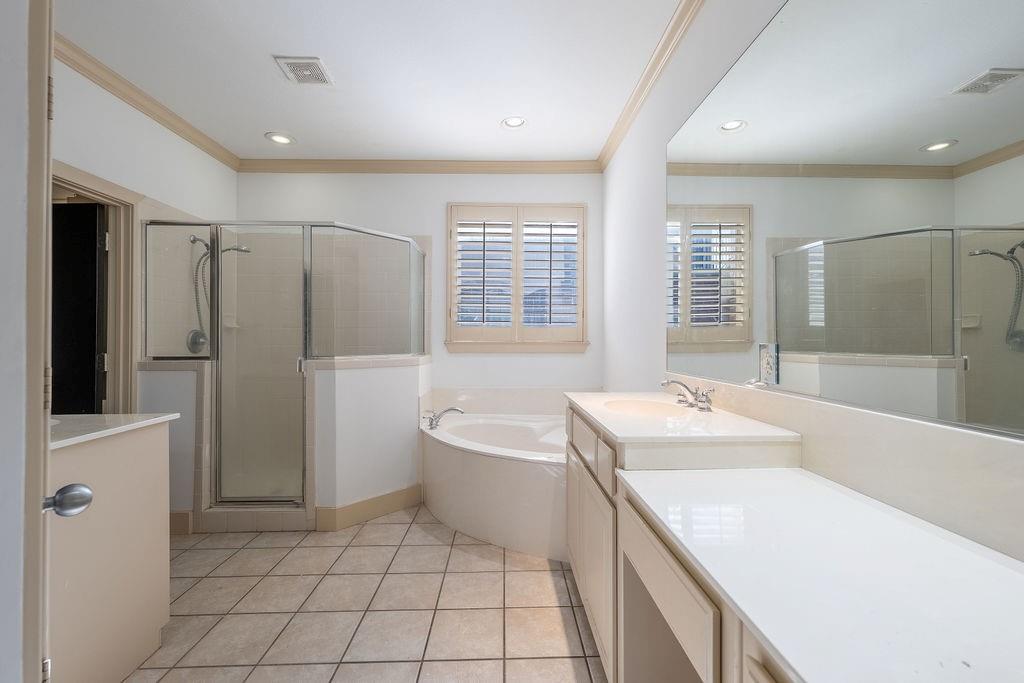 2706 Floyd Street Dallas, TX 75204 - Photo 16 of 22 a bath room with a sink a mirror and a bath tub