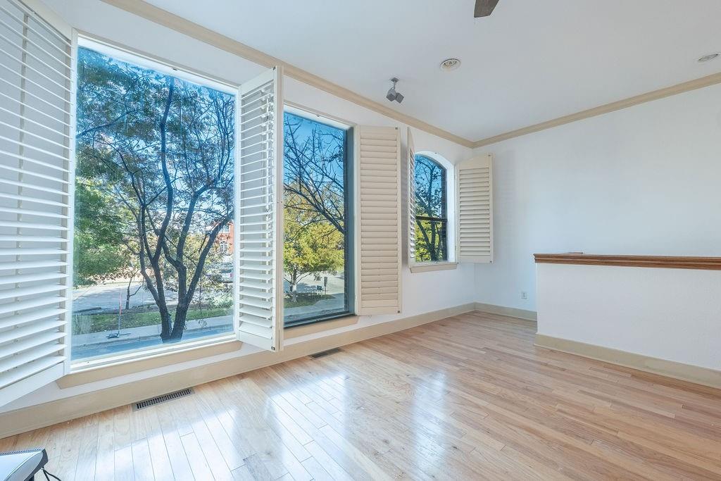 2706 Floyd Street Dallas, TX 75204 - Photo 9 of 22 a view of an empty room with wooden floor and a window