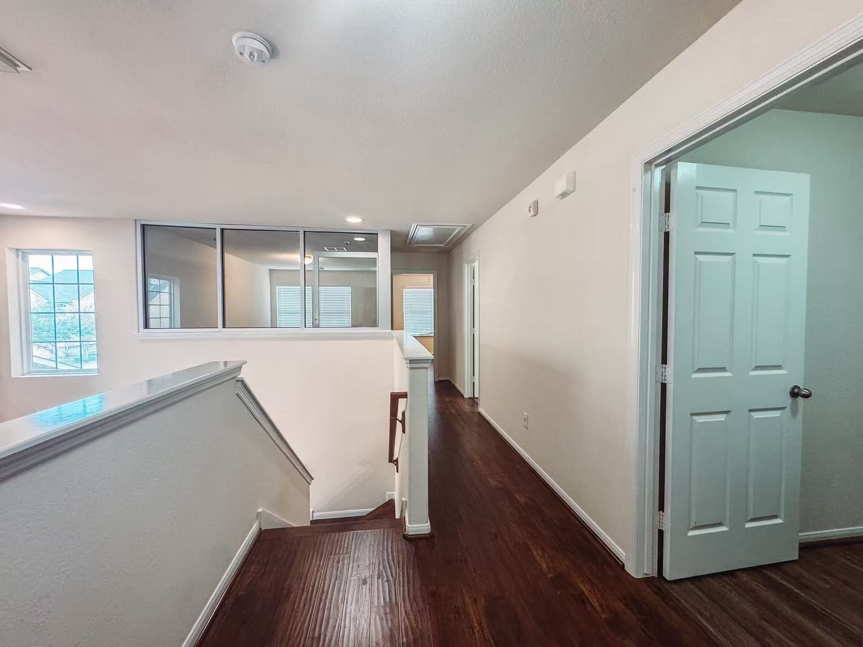 3923 Calgary Circle Missouri City, TX 77459 - Photo 11 of 25 a view of a hallway with wooden floor and staircase