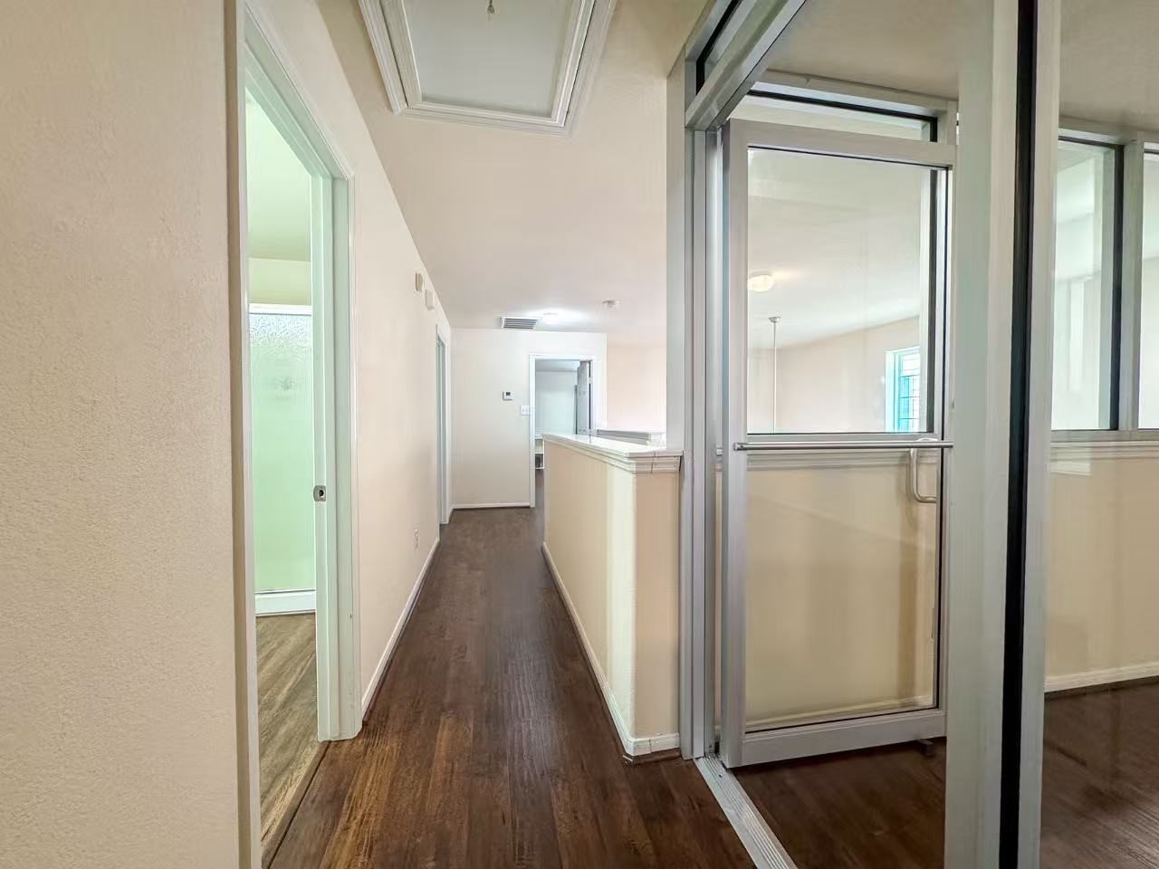 3923 Calgary Circle Missouri City, TX 77459 - Photo 12 of 25 a view of a hallway with wooden floor and staircase