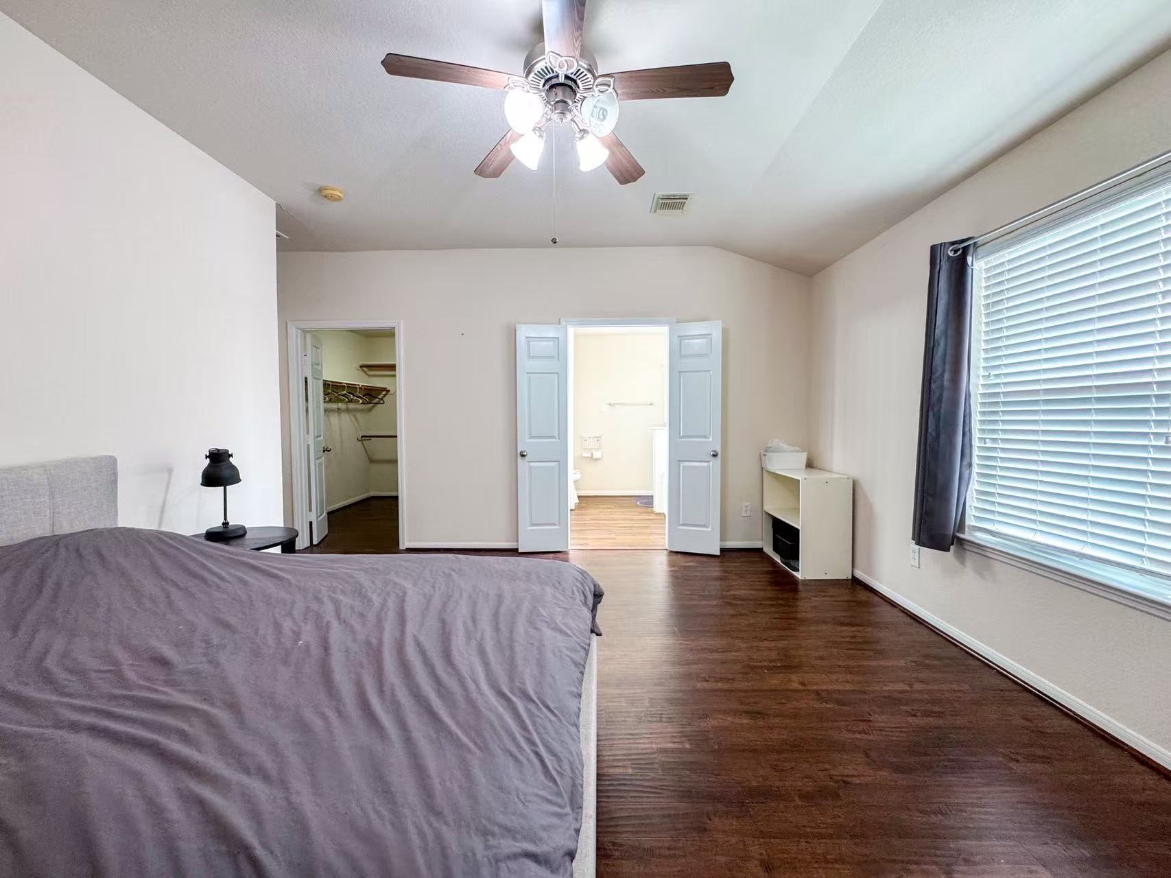 3923 Calgary Circle Missouri City, TX 77459 - Photo 14 of 25 a bedroom with a bed and a chandelier