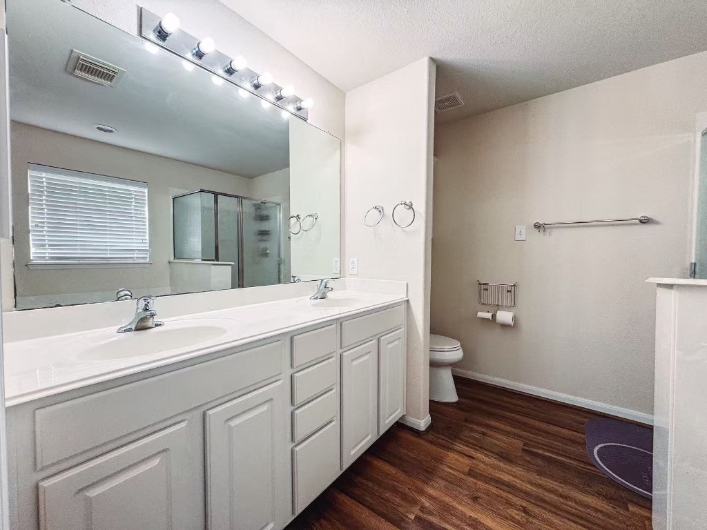 3923 Calgary Circle Missouri City, TX 77459 - Photo 16 of 25 a spacious bathroom with a double vanity sink a mirror and a toilet