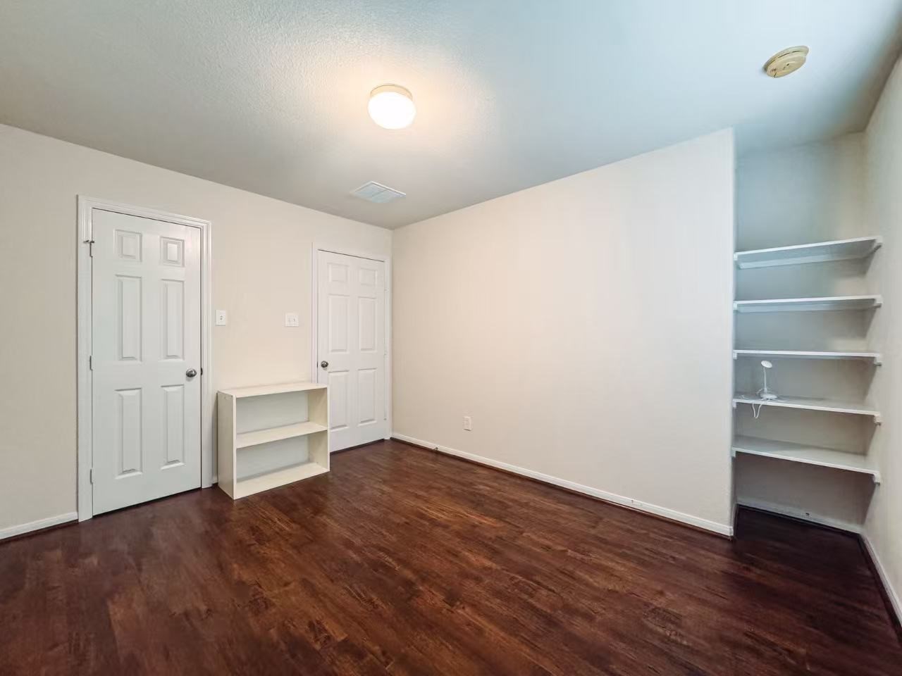 3923 Calgary Circle Missouri City, TX 77459 - Photo 18 of 25 a view of a room with wooden floor and brick wall