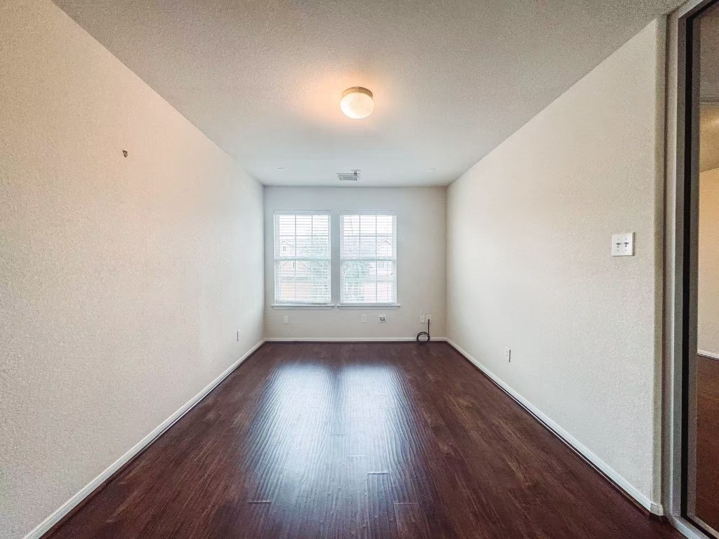 3923 Calgary Circle Missouri City, TX 77459 - Photo 20 of 25 an empty room with wooden floor and windows