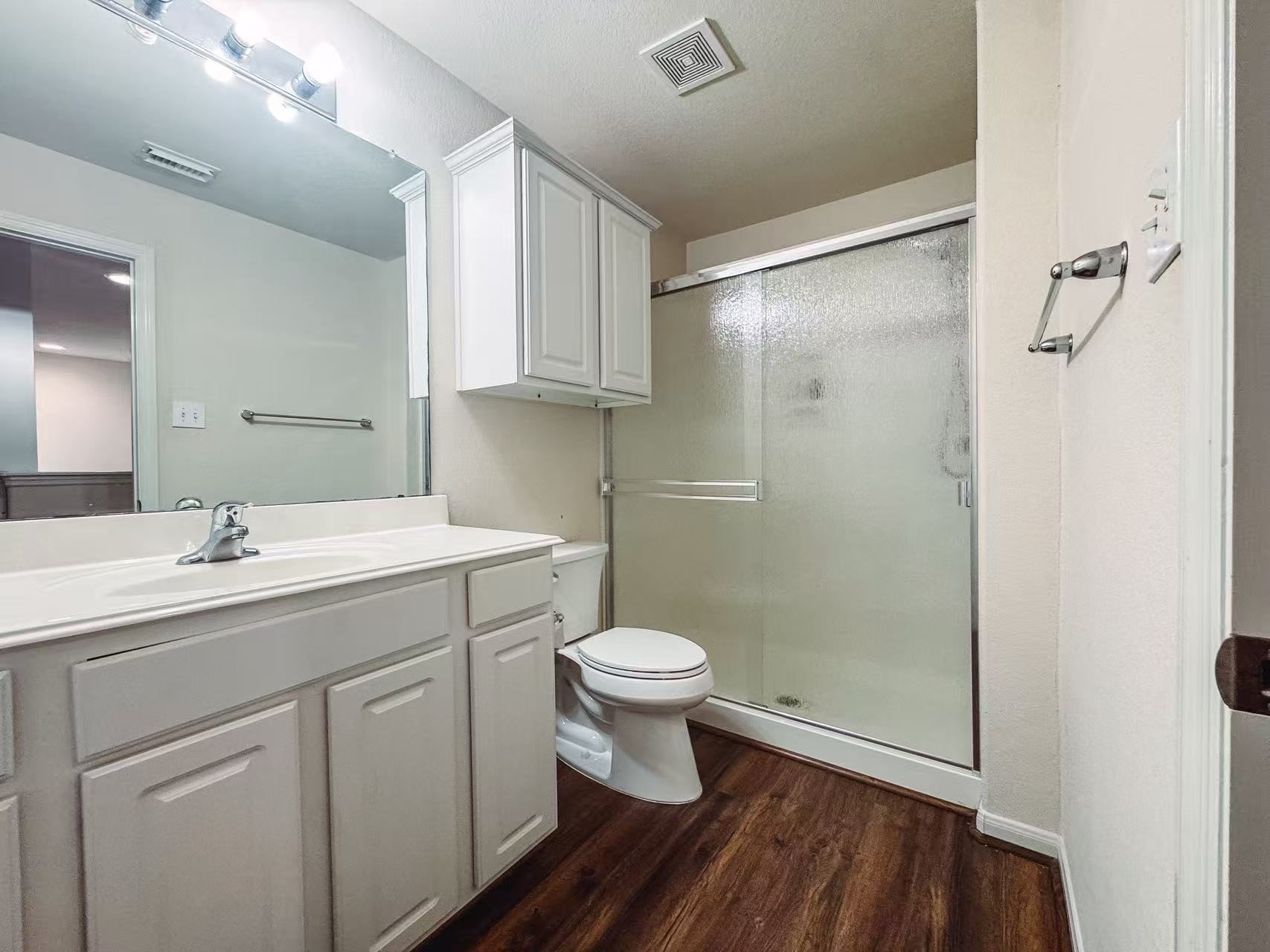3923 Calgary Circle Missouri City, TX 77459 - Photo 21 of 25 a bathroom with a sink a toilet a mirror and shower