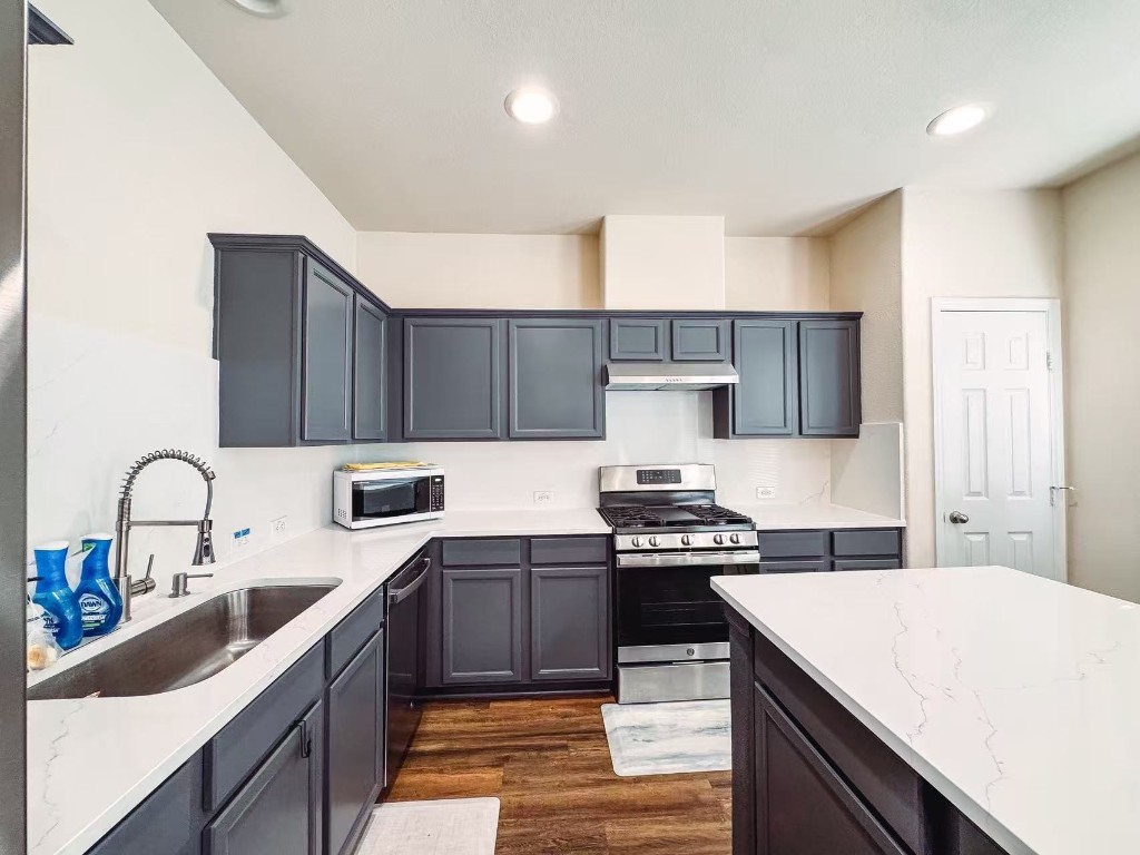 3923 Calgary Circle Missouri City, TX 77459 - Photo 7 of 25 a kitchen with a sink a stove and cabinets