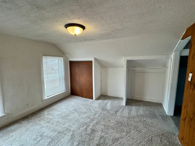 an empty room with closet area