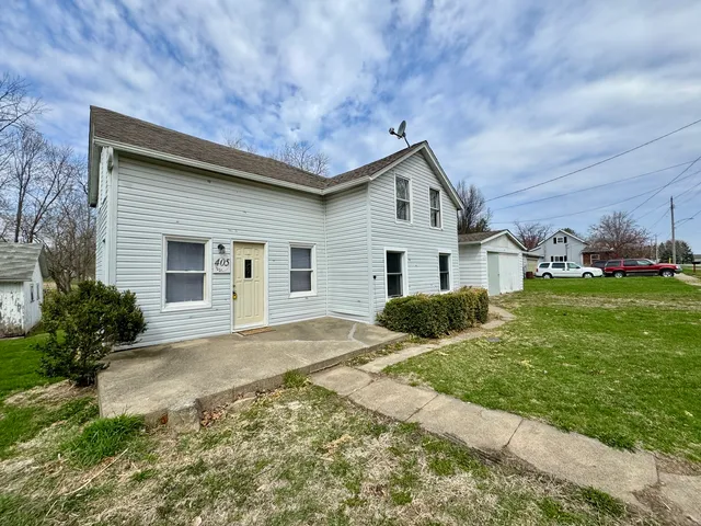 a front view of house with yard and green space