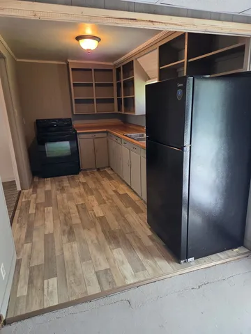 a kitchen with a refrigerator and a sink
