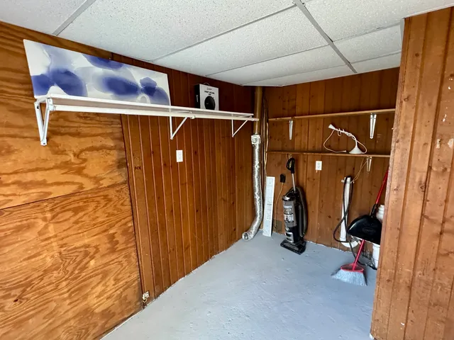 a view of walk in closet with clothes