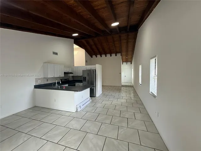 a view of a kitchen with a sink and cabinets