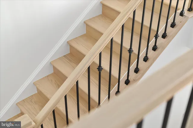 a view of a big house with a big yard and large tree