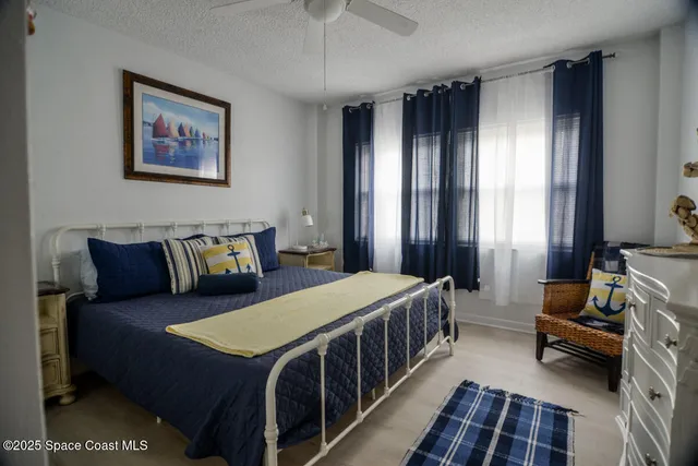 a bedroom with a bed a couch and dresser