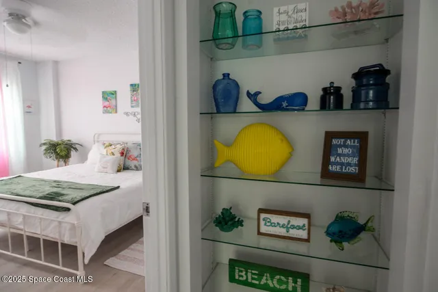 a bedroom with a bed and painting on the wall