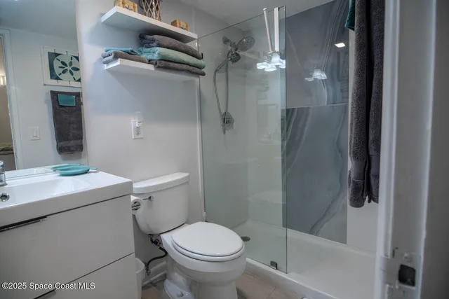 a bathroom with a shower a toilet and sink