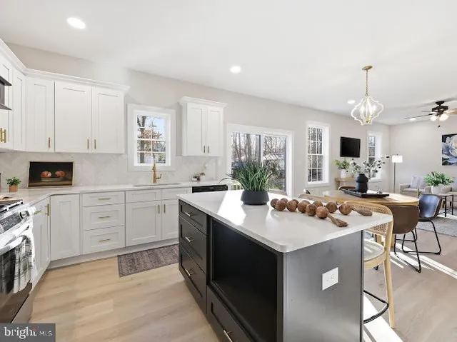 a kitchen with a sink stove and cabinets