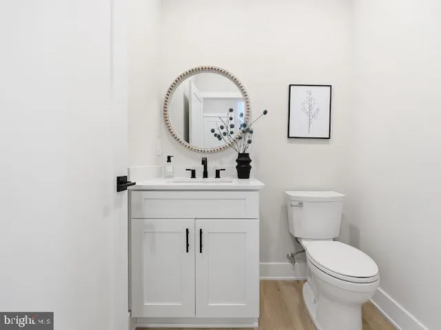 a bathroom with a toilet a sink and mirror
