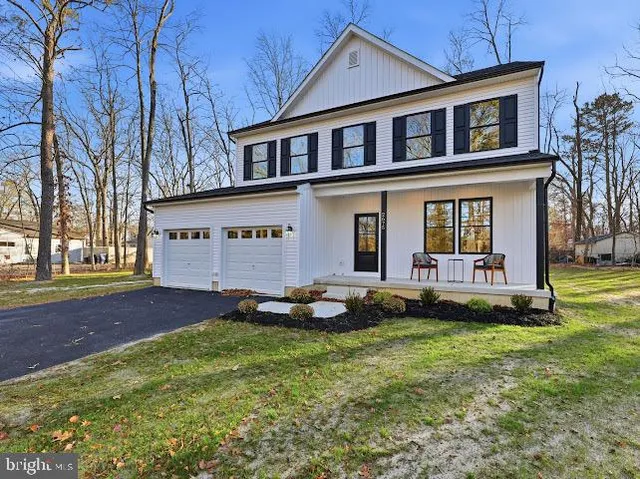 a view of an house with backyard space and garden