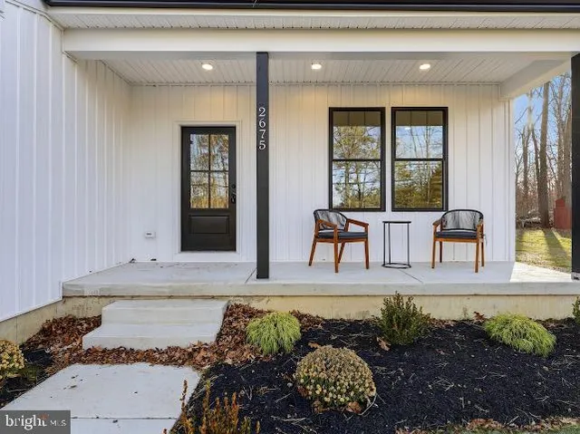 a view of a livingroom with furniture and floor to ceiling window