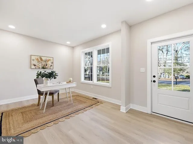 a view of a livingroom with furniture window and wooden floor