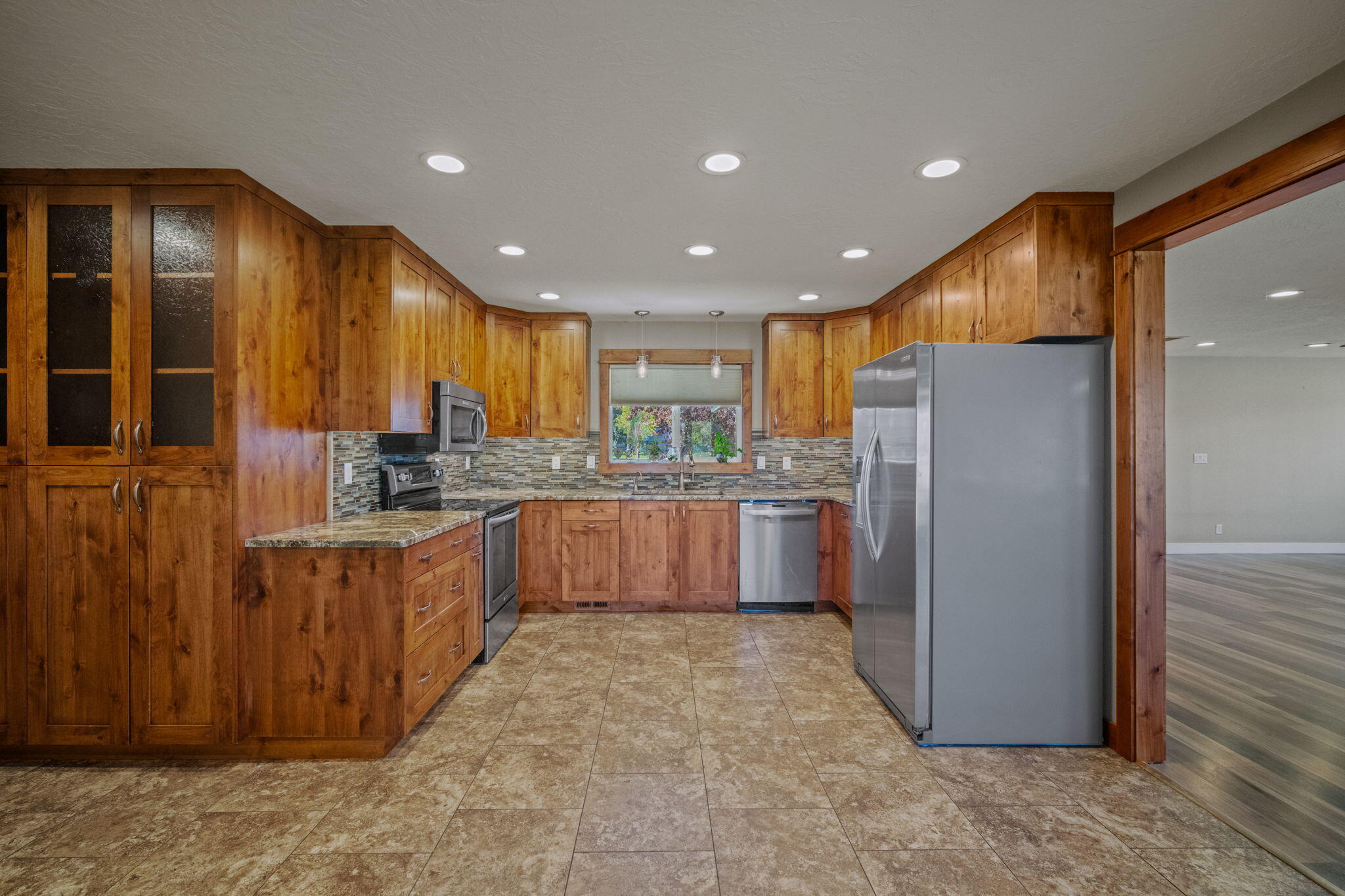 62466 Eagle Road Bend, OR 97701 - Photo 18 of 93 a kitchen with stainless steel appliances granite countertop a refrigerator a sink dishwasher and wooden cabinets