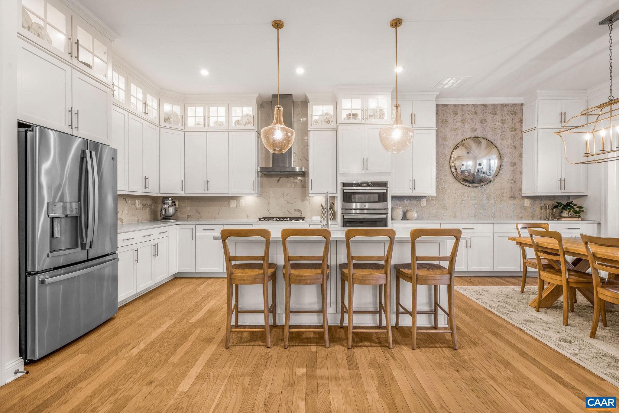 2744 Lockerbie Lane Keswick, VA 22947 - Photo 1 of 75 a kitchen with granite countertop a table chairs a sink dishwasher stove and cabinets