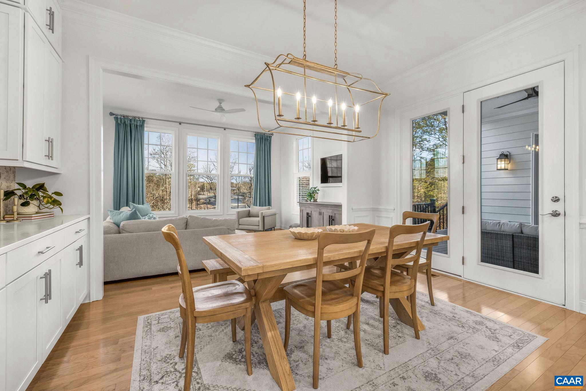 2744 Lockerbie Lane Keswick, VA 22947 - Photo 13 of 75 a dining room with furniture a chandelier and wooden floor