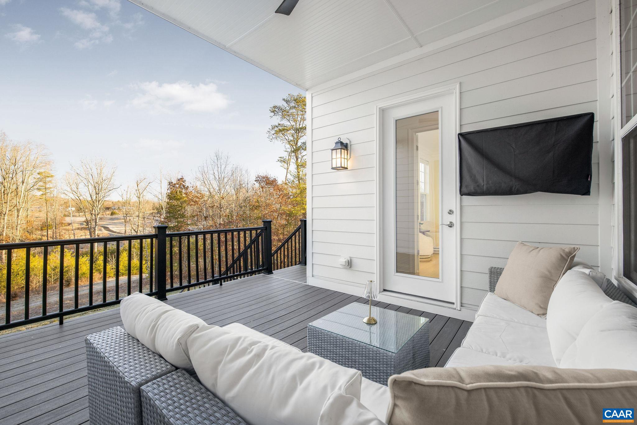 2744 Lockerbie Lane Keswick, VA 22947 - Photo 19 of 75 a balcony with furniture and a flat screen tv