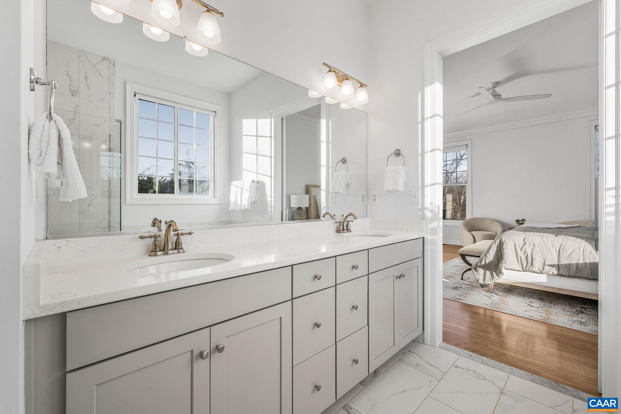 2744 Lockerbie Lane Keswick, VA 22947 - Photo 25 of 75 a spacious bathroom with a double vanity sink mirror and bathtub